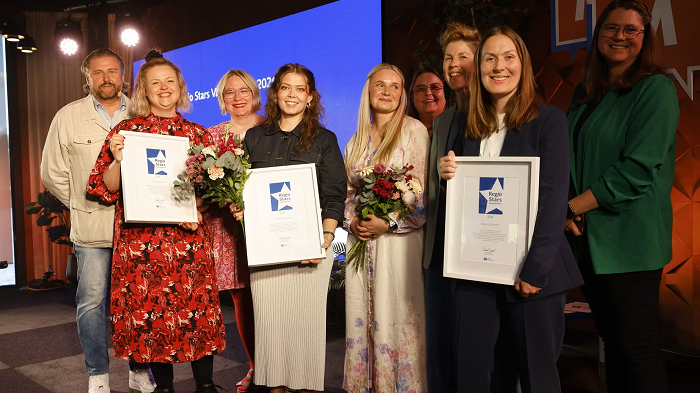 En bild på årets vinnare med diplom och blommor tillsammans med regional utvecklingsdirektör Patrik Sällström